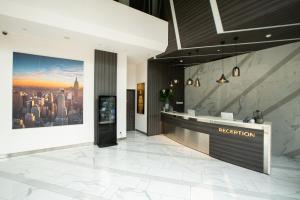 a hotel lobby with a reception desk and a city at Juno Tanah Abang Jakarta in Jakarta