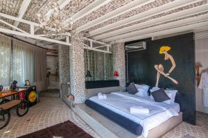 a person jumping in the air on top of a bed at Ölüdeniz Loft - Adults Only in Oludeniz