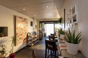 a room with chairs and a table with plants at Hôtel Restaurant Splendid Camargue in Le Grau-du-Roi