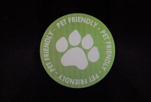 a green sticker with a paw print on it at Bungalow33 Benllech in Benllech