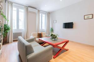 a living room with a table and chairs and a tv at Apartment Egidio in Florence