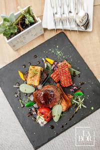 a plate of food with meat and vegetables on a table at LaBor Kvártély in Tokaj