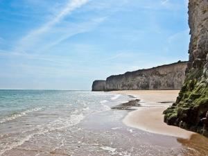 a beach with the ocean and a rocky shore at Picturesque Seaside Cottage Next to Viking Bay - Broadstairs in Broadstairs