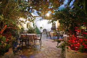 a restaurant with tables and chairs in a courtyard at Le Magnolia in Calvi