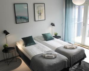 two beds in a bedroom with two pillows on them at Forenom Serviced Apartments Vantaa Jokiniemi in Vantaa