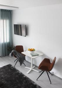 a white table and two chairs in a room at Forenom Serviced Apartments Vantaa Jokiniemi in Vantaa