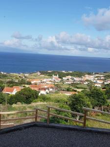 a view of the ocean and a town at Barrocas do Mar in Prainha de Baixo