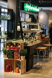 a food counter with vegetables on display in a restaurant at Hotel Ravna Gora in Ravna Gora