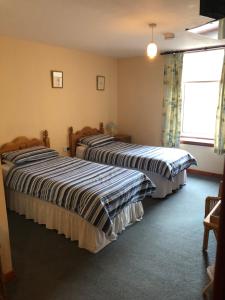 A bed or beds in a room at Invernettie guesthouse