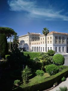 a large building with a garden in front of it at TH Roma - Carpegna Palace in Rome