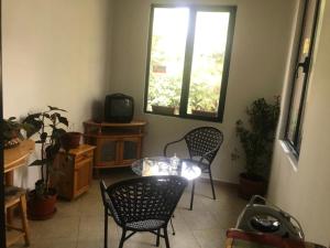 a room with two chairs and a table and a tv at Нощувки Шумен in Shumen
