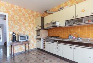 a kitchen with a sink and a microwave at Villa Georges in Foix