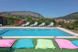 a swimming pool with four pillows on the ground next to at Villa Georges in Foix