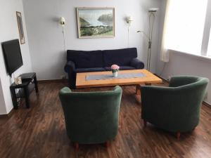a living room with a couch and a table and chairs at Marifjøra Sjøbuer in Marifjora