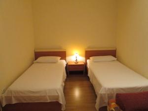 Postel nebo postele na pokoji v ubytování Apartments Villa Fernetich