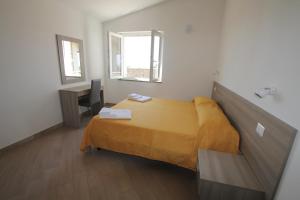 A bed or beds in a room at Appartamenti Torre