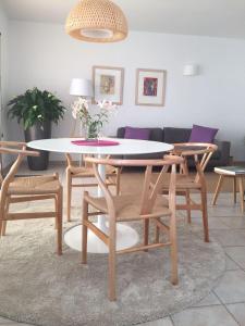 a dining table and chairs in a living room at Bungalow La Datura in El Paso