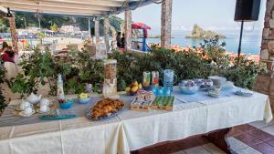 a table with food on it next to the ocean at La Tonnara B&B in Palmi