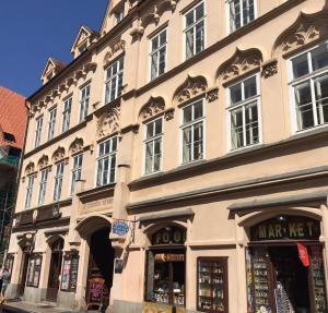 a large building with a store in front of it at NEW DESIGN & STYLE Apartment Old Town XXL in Prague