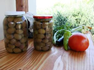 two jars of beans and vegetables on a table at Karpetis a green paradise in Psakoudia
