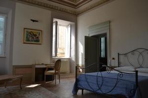 Postel nebo postele na pokoji v ubytování Palazzo Roberti