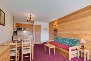 a living room with a bench and a kitchen at Vacancéole - Résidence Saint Christophe in Les Deux Alpes +6 photos