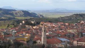 a view of a city with buildings and mountains at Sa Mendula in Bonorva