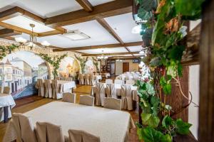 a banquet hall with white tables and chairs at Zatyshok in Vinnytsya