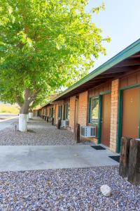 a building with a tree in front of it at Roosevelt Resort Park in Roosevelt