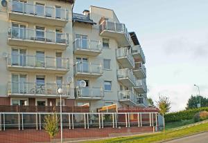 a tall building with balconies on the side of it at IRS ROYAL APARTMENTS Apartamenty IRS Morenowe Wzgórza in Gdańsk +9 photos