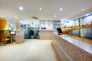 a hotel lobby with a pool and a piano at Crisol Alisios Canteras in Las Palmas de Gran Canaria