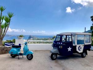 a small golf cart parked next to a scooter at Relais Bijoux Ischia in Ischia