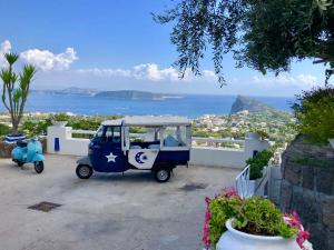 a golf cart parked on the side of a house at Relais Bijoux Ischia in Ischia