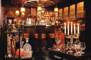 a bar with candles on a table in a room at Hotel Ostmeier in Bochum