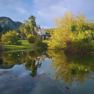 a reflection of a house in the water at Val d'Or Estate in Franschhoek