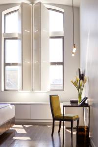 a dining room with a chair and a table at Hotel St Paul in Montréal