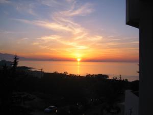 a sunset from the balcony of a building at Rethymno Mare Royal & Water Park in Skaleta
