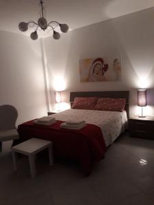 a bedroom with a bed and two lamps and a chair at Belvedere in Policoro