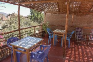 a patio with tables and chairs on a balcony at Brabant Hostal in Nazca