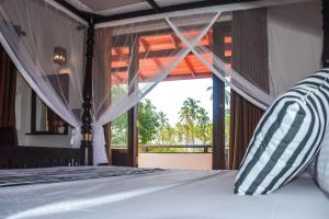 ein Schlafzimmer mit einem Bett mit Blick auf das Meer in der Unterkunft Janu Homestay in Tangalle