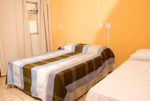 Orquídea Hotel tesisinde bir odada yatak veya yataklar