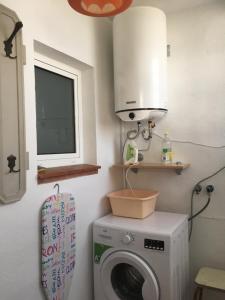 uma cozinha com uma máquina de lavar roupa e um micro-ondas em Bel Appartement vue Mer em Roses