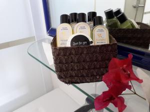 a basket of soap and a red flower on a table at Boutique Hostal "Casa Justa" in Mojácar