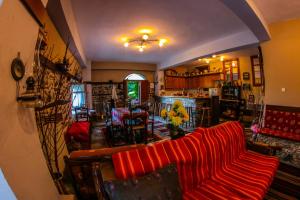 uma sala de estar com um sofá vermelho e uma sala de jantar em Mylos em Arkochórion