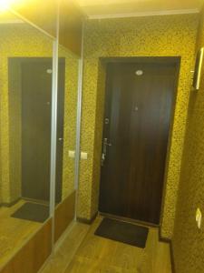 a hallway with a door and mirrors in a room at Апартаменти біля дельфінарію in Truskavets +9 photos