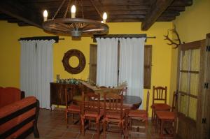 a dining room with a table and chairs at Casa Rural El Pedroso in Villar del Pedroso