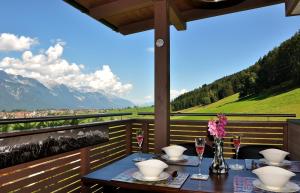 a table on a balcony with a view of mountains at Appartment Sofi - Enjoy The View - Axams,Innsbruck Tirol in Innsbruck