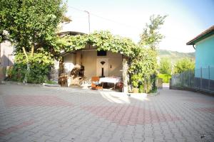a building with a patio with a table in it at Pensiunea Irina in Brad