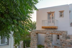 Casa bianca con balcone e albero di Castle Mansions a Naxos Chora