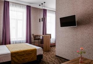 a hotel room with a bed and a television at Florinn hotel in Moscow